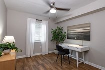 Transform a bedroom into your cozy retreat, featuring chic wood floors and a blissful ceiling fan. 