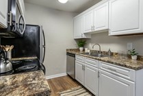 Embrace culinary creativity in our galley-style kitchens with ample cabinetry for optimal storage and organization.